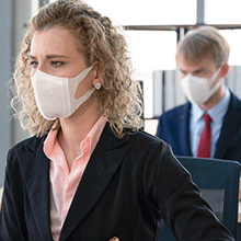 Office workers wearing face mask while working