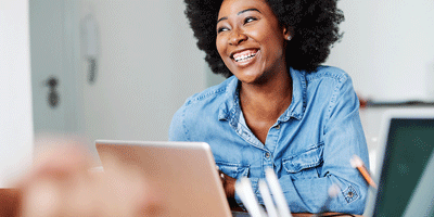 Smiling woman working on laptop