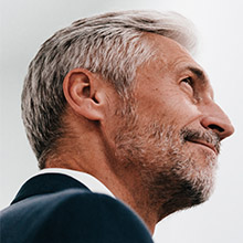 Side profile of bearded smiling man