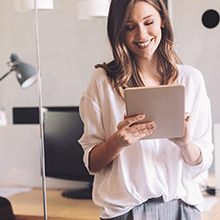 Smiling woman working on tablet
