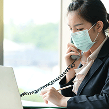 Woman wearing face mask having phone conversation