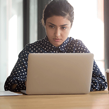 Woman focused on working on laptop
